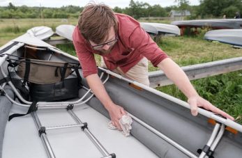 Photo d'un homme qui nettoie son bateau avec une lingette